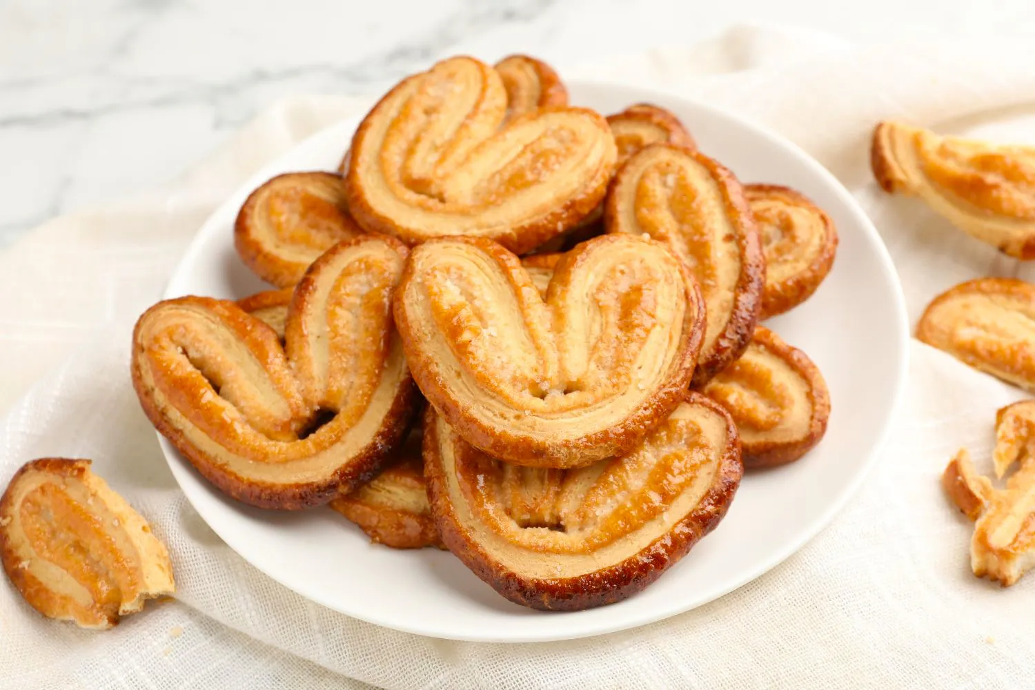 Heart-shaped palmier cookies on a plate at Dragon Bay Bakery, a Chinese Bakery in Brooklyn