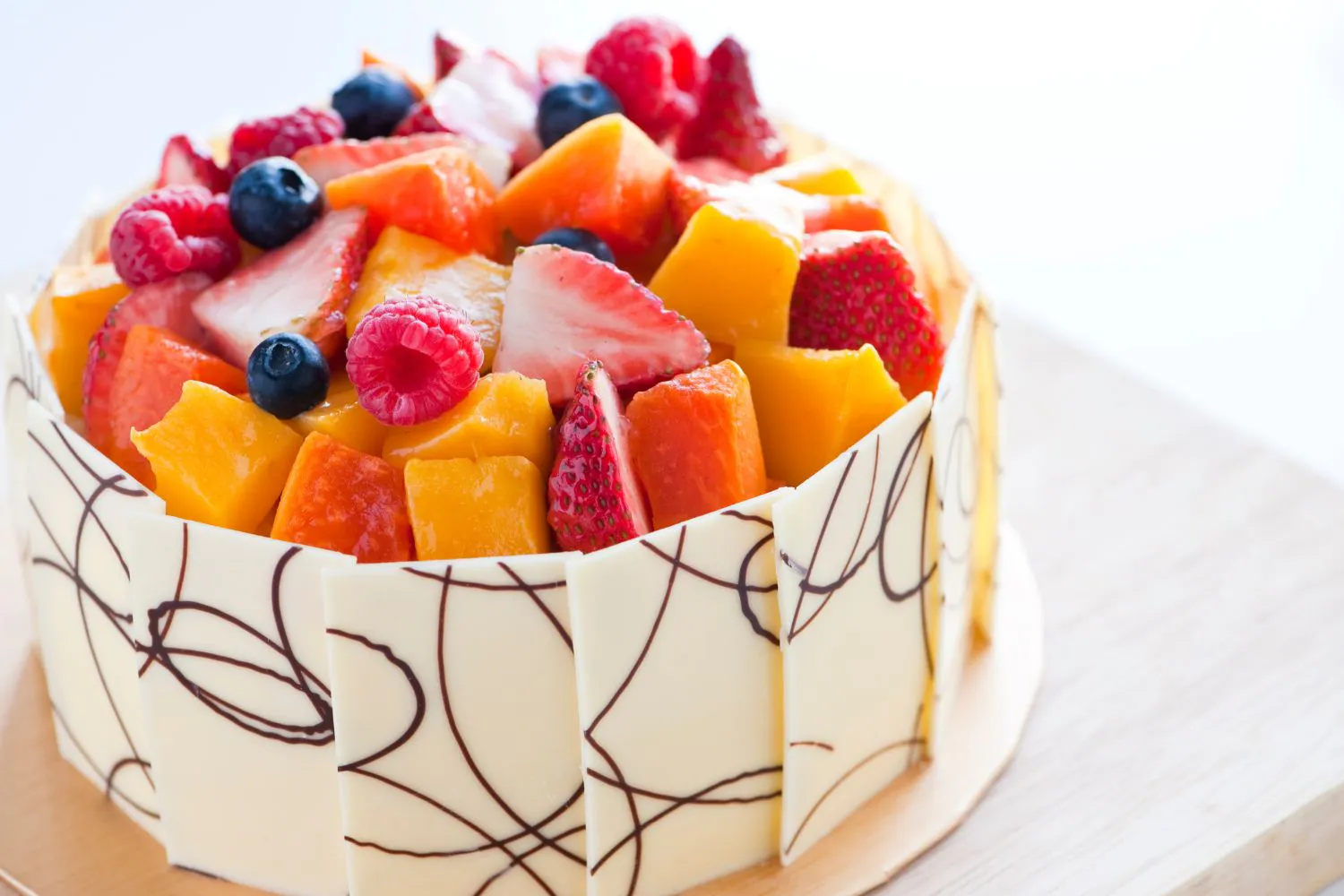 Fresh fruit cake with white chocolate shards at Dragon Bay Bakery, a Chinese Bakery in Brooklyn
