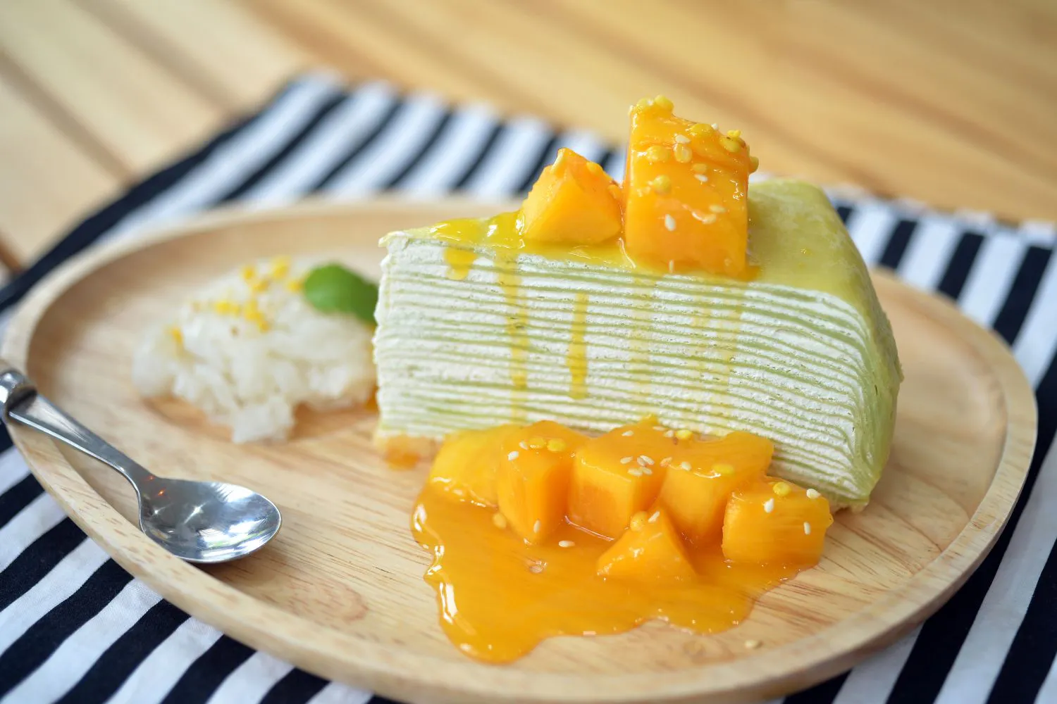Mango crepe cake slice with mango sauce at Dragon Bay Bakery, a Chinese Bakery in Brooklyn