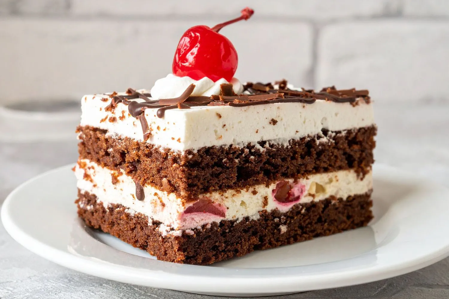 Black forest cake slice with cherry and chocolate at Dragon Bay Bakery, a Chinese Bakery in Brooklyn